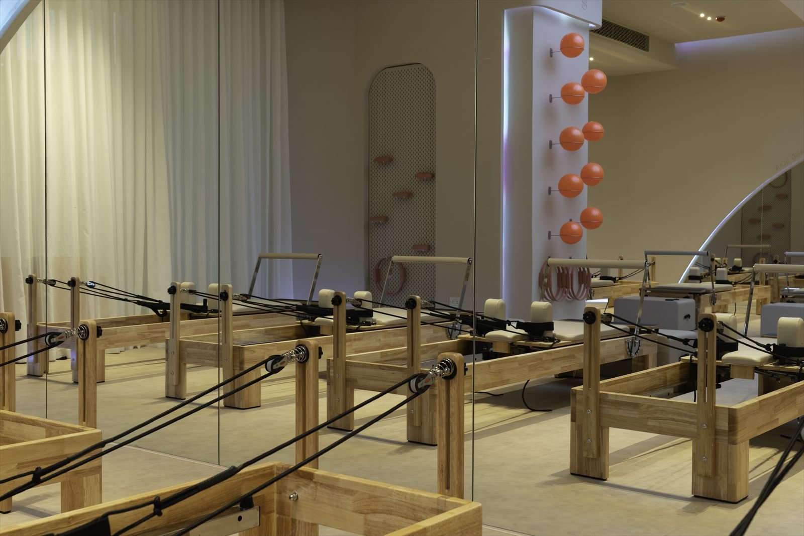 Mirrored reformer Pilates floor with wall-mounted props at Studio 8, New Cairo
